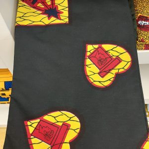 A black and yellow fabric with red and yellow designs.