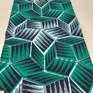 A table runner with green and black cubes on it.