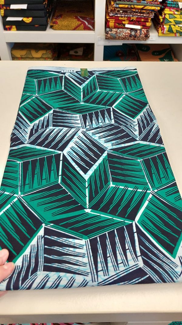 A table runner with green and black cubes on it.