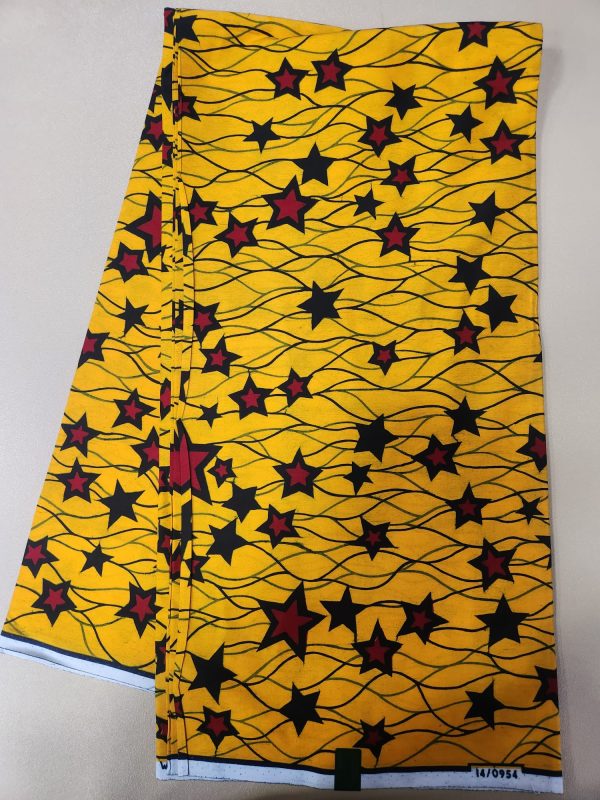 A yellow and black fabric with red stars