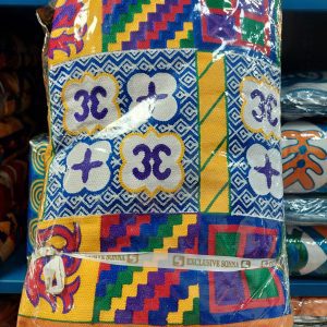 A bag of colorful cloth sitting on top of a shelf.