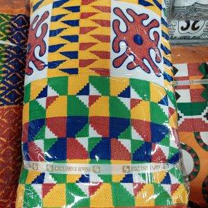 A colorful pillow sitting on top of a blanket.