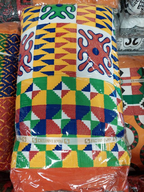 A colorful pillow sitting on top of a blanket.