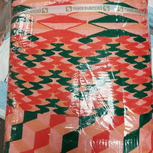 A red and green pattern is wrapped in plastic.